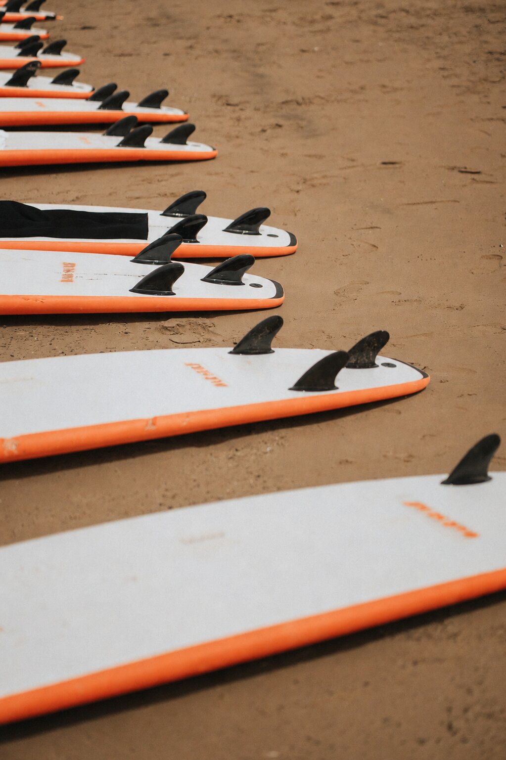 Group of NAVA surfers on the beach with their boards