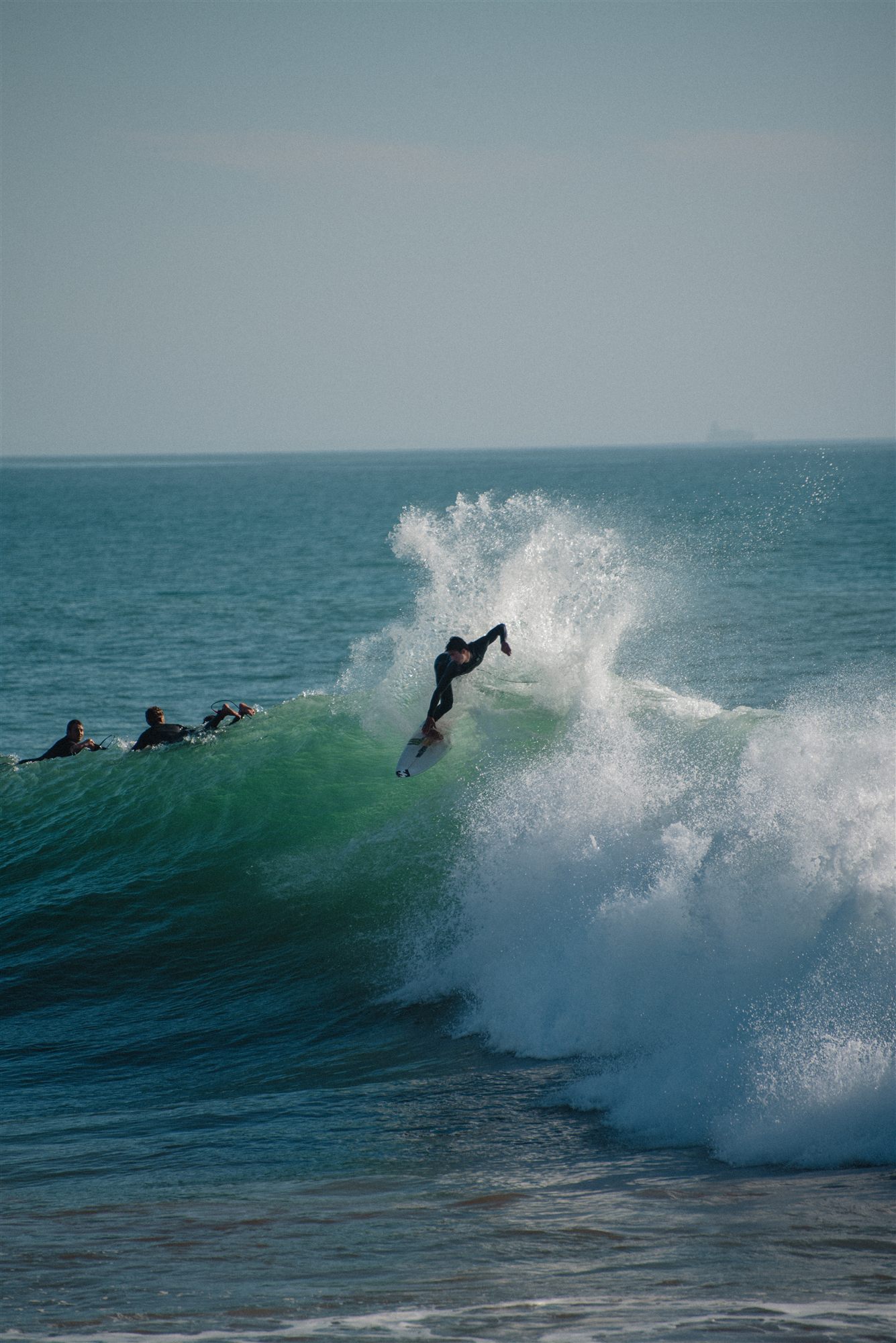 Surfer dropping into a green wave near Tamraght, Morocco