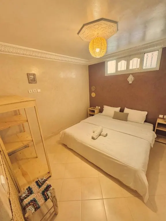 Private room with double bed and Moroccan ceiling lamp at NAVA surf camp, Tamraght