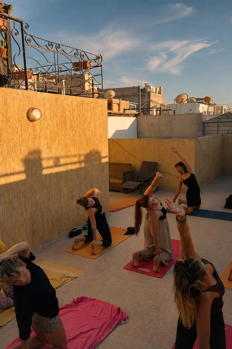 Rooftop yoga session at sunset in Tamraght