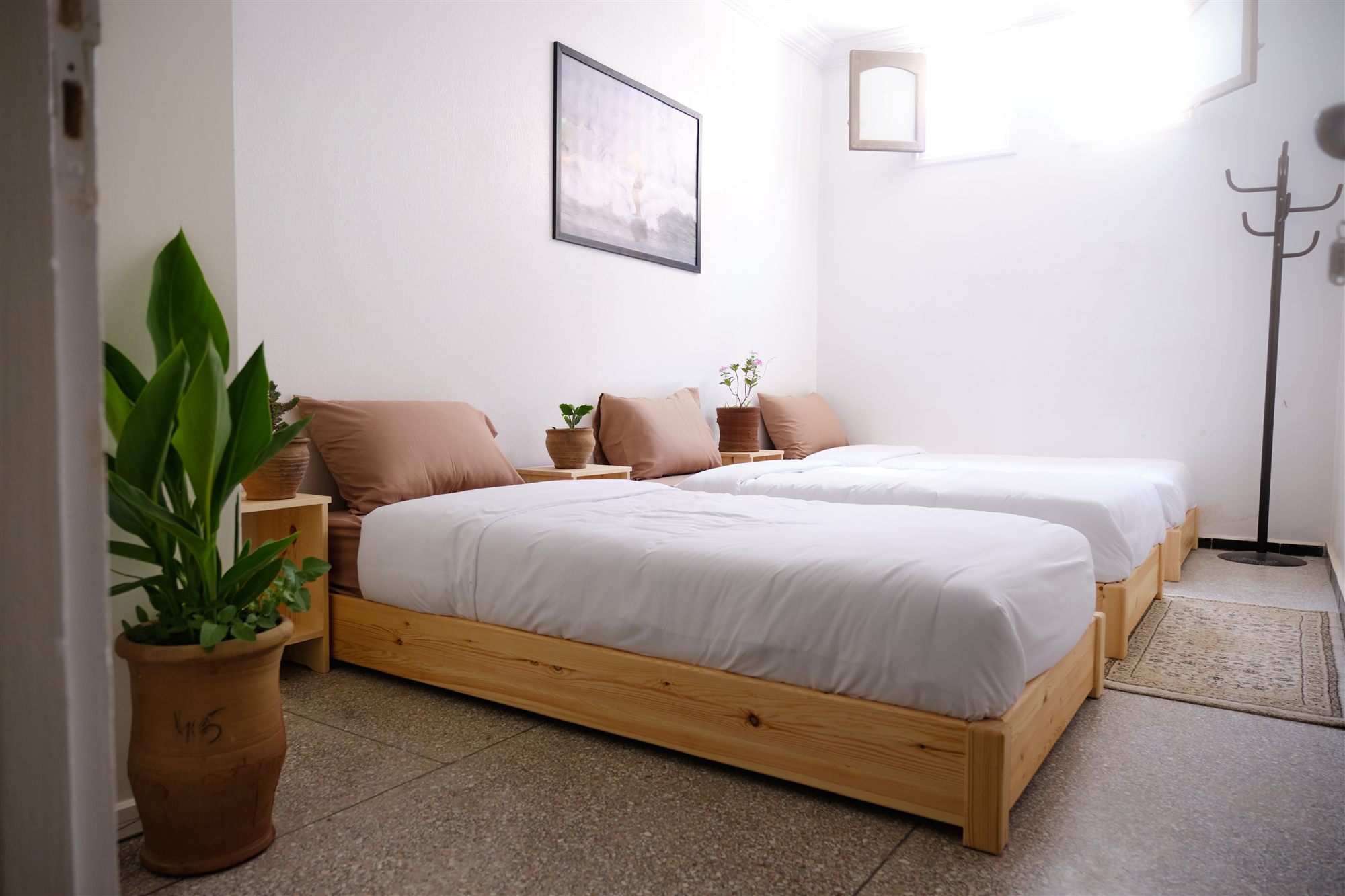 Bright twin room at the NAVA surf house