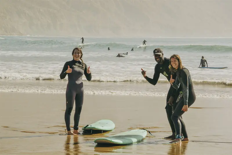 Surf coach and guest on the beach at NAVA in Tamraght